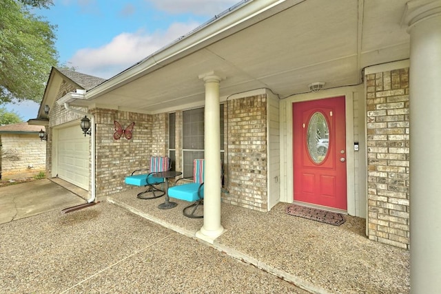 9602 Tea Rose Trl, Austin, TX 78748 - doorway to property with brick siding, a porch, an attached garage, and driveway