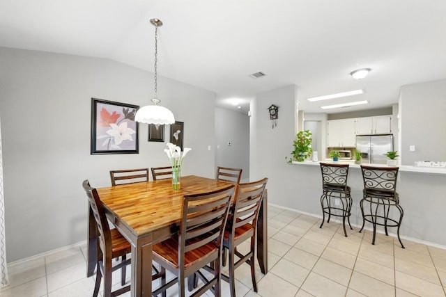 9602 Tea Rose Trl, Austin, TX 78748 - dining space with light tile patterned flooring and vaulted ceiling