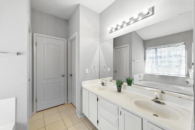 9602 Tea Rose Trl, Austin, TX 78748 - full bathroom featuring double vanity, a garden tub, tile patterned floors, and a closet