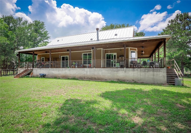 209 Old Sayers Rd, Elgin, TX 78621 - rear view of property with stairs, a yard, and a metal roof