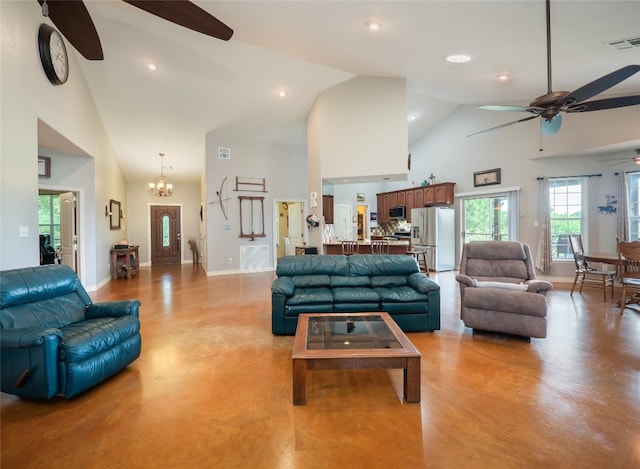 209 Old Sayers Rd, Elgin, TX 78621 - living room featuring a ceiling fan, finished concrete floors, high vaulted ceiling, a chandelier, and healthy amount of natural light