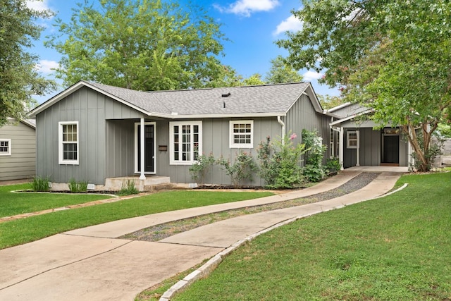 5212 Valley Oak Dr, Austin, TX 78731 - ranch-style house featuring a front yard, roof with shingles, and board and batten siding