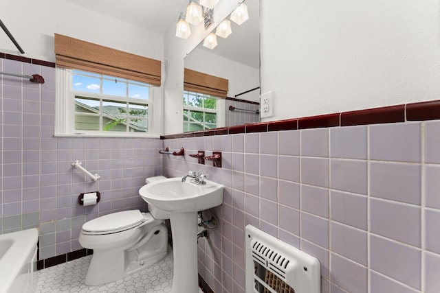 5212 Valley Oak Dr, Austin, TX 78731 - bathroom with heating unit, tile walls, a bathtub, a shower, and tile patterned flooring