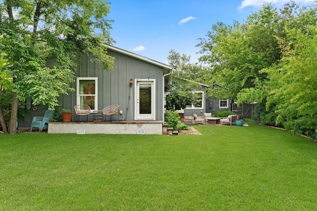 5212 Valley Oak Dr, Austin, TX 78731 - back of house with board and batten siding and a lawn