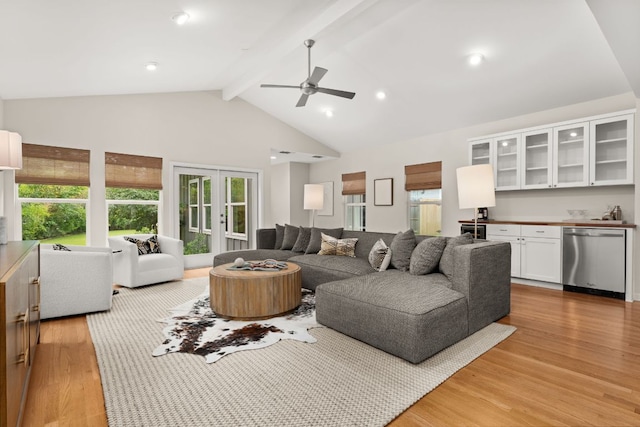 5212 Valley Oak Dr, Austin, TX 78731 - living area with light wood finished floors, beamed ceiling, ceiling fan, and high vaulted ceiling