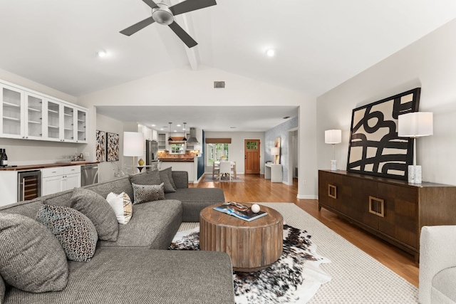 5212 Valley Oak Dr, Austin, TX 78731 - living room featuring wine cooler, bar with sink, light wood-type flooring, and a ceiling fan