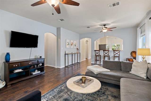9204 Brents Elm Dr, Austin, TX 78744 - living room featuring a ceiling fan, arched walkways, and wood finished floors