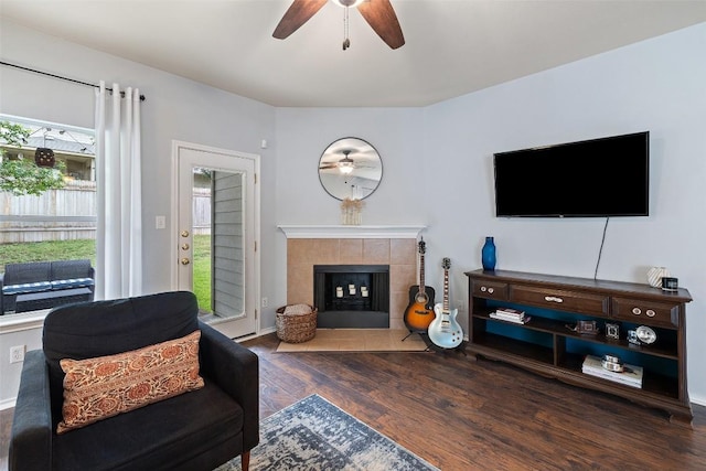 9204 Brents Elm Dr, Austin, TX 78744 - living area with a ceiling fan, wood finished floors, and a tiled fireplace