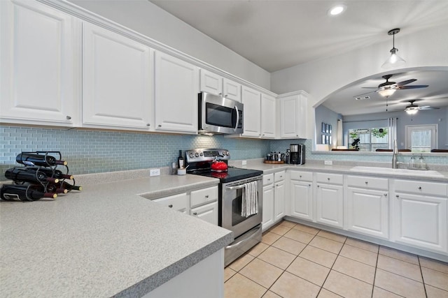 9204 Brents Elm Dr, Austin, TX 78744 - kitchen featuring stainless steel appliances, ceiling fan, decorative backsplash, light countertops, and recessed lighting