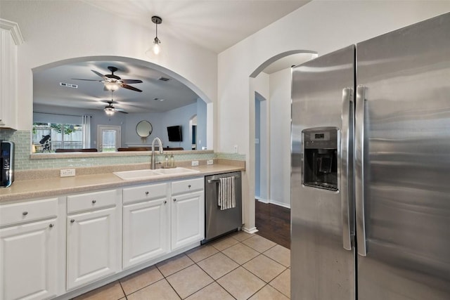 9204 Brents Elm Dr, Austin, TX 78744 - kitchen with stainless steel appliances, a ceiling fan, tasteful backsplash, and light countertops