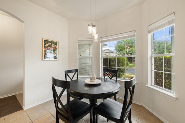 9204 Brents Elm Dr, Austin, TX 78744 - dining room with light tile patterned flooring and arched walkways