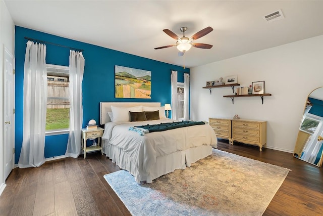 9204 Brents Elm Dr, Austin, TX 78744 - bedroom with dark wood finished floors and a ceiling fan