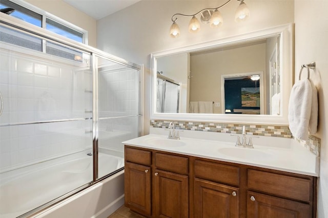 9204 Brents Elm Dr, Austin, TX 78744 - full bathroom with enclosed tub / shower combo, backsplash, and double vanity