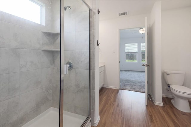 421 Bluejack Way, Hutto, TX 78634 - bathroom featuring healthy amount of natural light, a shower stall, wood finished floors, and ceiling fan