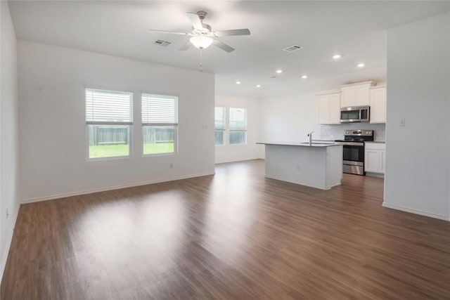 421 Bluejack Way, Hutto, TX 78634 - unfurnished living room with a ceiling fan, dark wood-type flooring, and recessed lighting