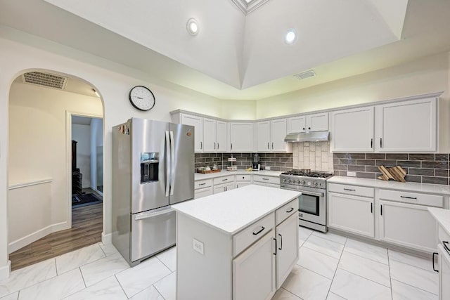 500 Olympic Dr, Pflugerville, TX 78660 - kitchen with stainless steel appliances, under cabinet range hood, light countertops, a kitchen island, and recessed lighting