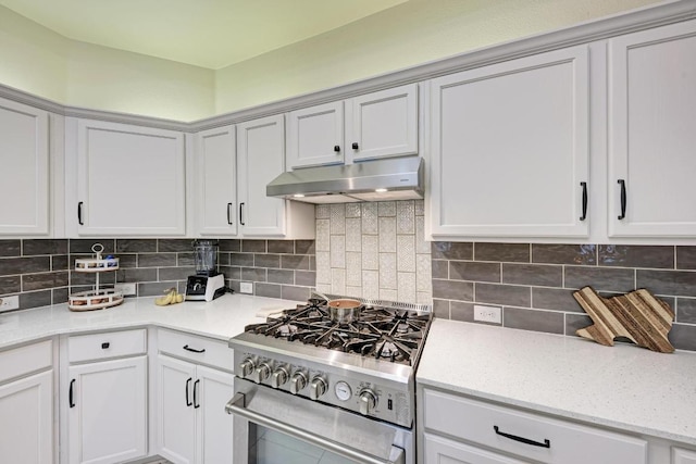 500 Olympic Dr, Pflugerville, TX 78660 - kitchen featuring under cabinet range hood, stainless steel range with gas stovetop, decorative backsplash, and white cabinetry