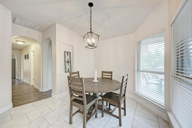 500 Olympic Dr, Pflugerville, TX 78660 - dining space featuring arched walkways, plenty of natural light, and a chandelier