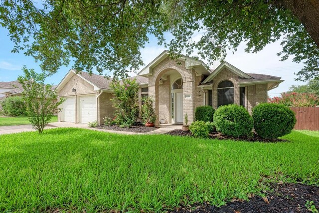 500 Olympic Dr, Pflugerville, TX 78660 - traditional home featuring brick siding, a garage, and driveway