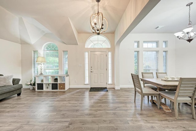 500 Olympic Dr, Pflugerville, TX 78660 - entryway with a chandelier, wood finished floors, and a towering ceiling