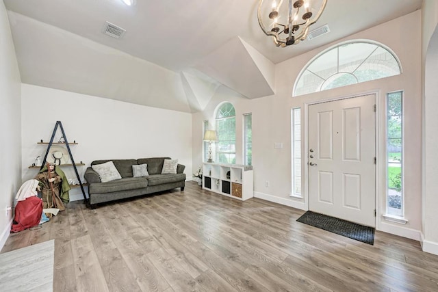 500 Olympic Dr, Pflugerville, TX 78660 - foyer entrance with a chandelier, light wood finished floors, healthy amount of natural light, and vaulted ceiling
