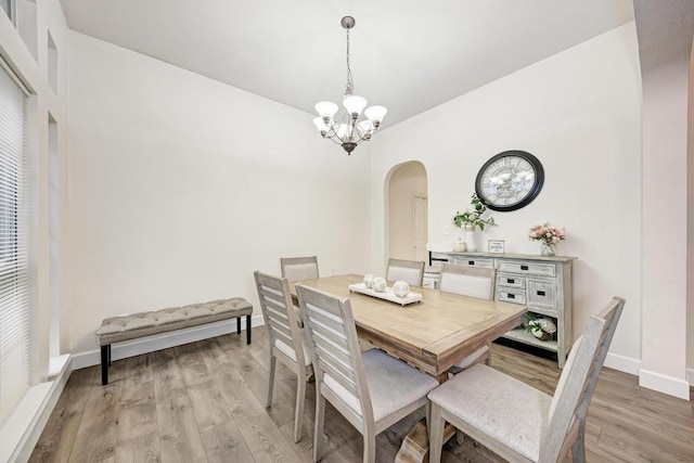 500 Olympic Dr, Pflugerville, TX 78660 - dining space with a chandelier, arched walkways, and light wood-style flooring