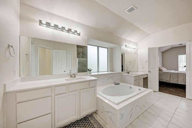 500 Olympic Dr, Pflugerville, TX 78660 - full bathroom featuring lofted ceiling, a bath, vanity, walk in shower, and connected bathroom