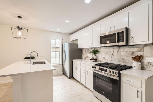 901 Garden Meadow Dr, Georgetown, TX 78628 - kitchen featuring appliances with stainless steel finishes, a peninsula, decorative backsplash, white cabinets, and light countertops