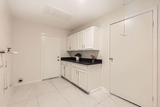 901 Garden Meadow Dr, Georgetown, TX 78628 - laundry room featuring light marble finish flooring, cabinet space, and hookup for a washing machine