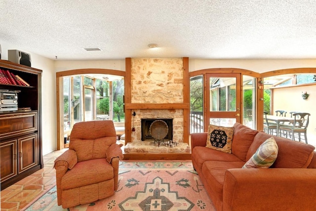 2500 Dana Cv, Austin, TX 78746 - living area featuring a textured ceiling, plenty of natural light, and a fireplace