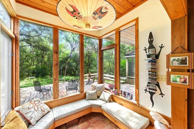 2500 Dana Cv, Austin, TX 78746 - sunroom with a textured wall, tile patterned flooring, and view of scattered trees