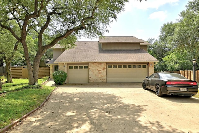 2500 Dana Cv, Austin, TX 78746 - view of front of house with driveway, a shingled roof, and a garage
