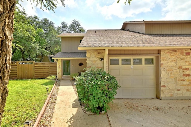 2500 Dana Cv, Austin, TX 78746 - townhome / multi-family property featuring stone siding, a shingled roof, and a garage