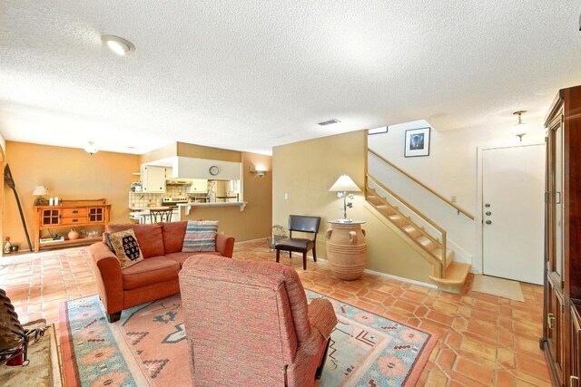 2500 Dana Cv, Austin, TX 78746 - living area with a textured ceiling and stairway
