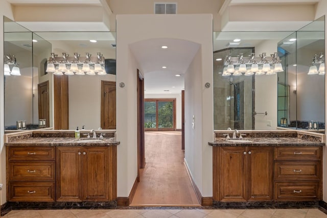 8140 Joy Rd, Volente, TX 78641 - bathroom with two vanities, tile patterned flooring, and recessed lighting