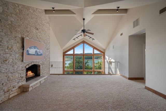 8140 Joy Rd, Volente, TX 78641 - unfurnished living room featuring carpet floors, ceiling fan, a stone fireplace, high vaulted ceiling, and beamed ceiling