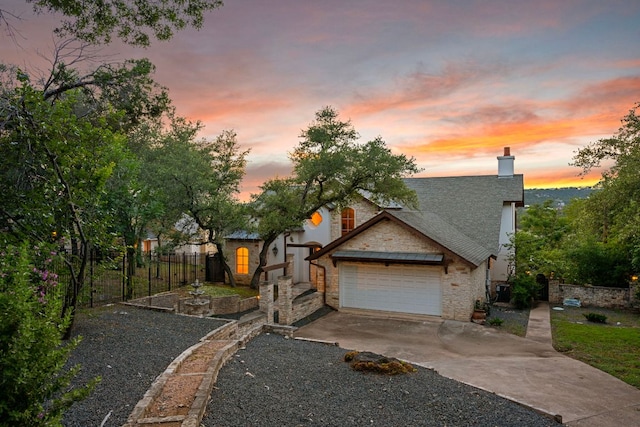 8140 Joy Rd, Volente, TX 78641 - view of front facade featuring driveway, a chimney, an attached garage, and stone siding