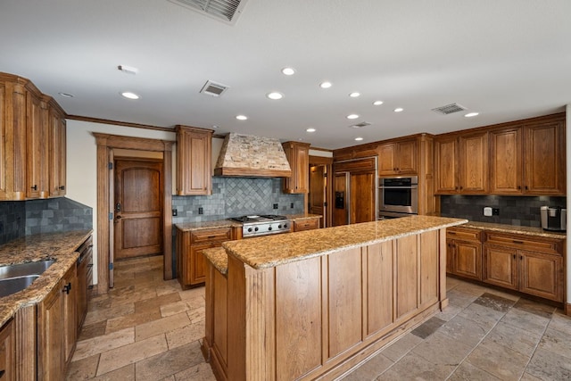 8140 Joy Rd, Volente, TX 78641 - kitchen featuring custom range hood, stainless steel appliances, backsplash, recessed lighting, and stone tile flooring