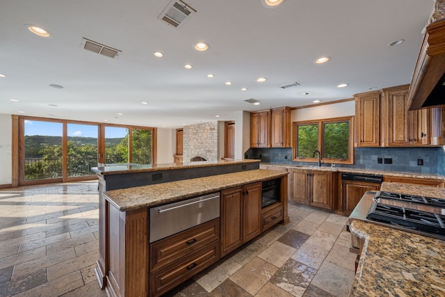 8140 Joy Rd, Volente, TX 78641 - kitchen featuring a warming drawer, stone tile flooring, recessed lighting, backsplash, and a kitchen island