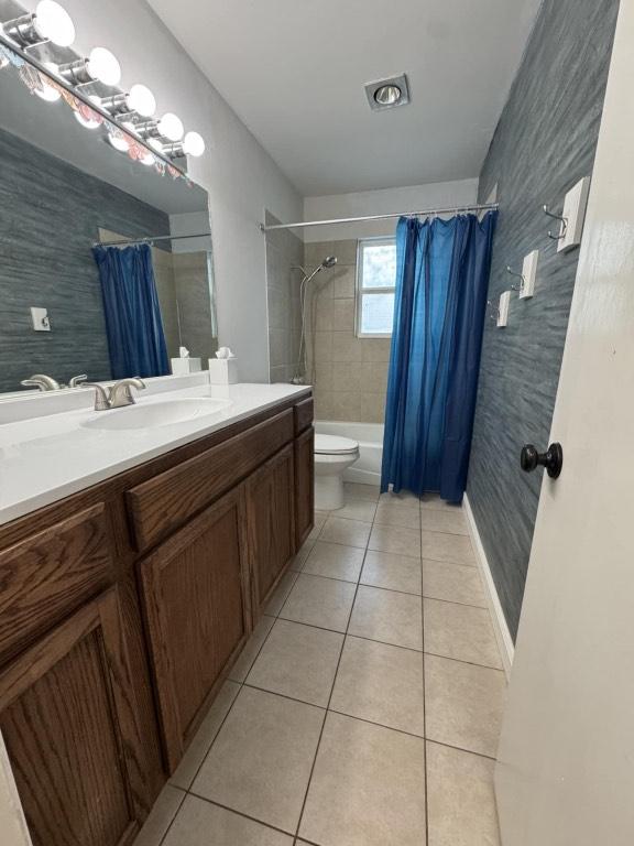 607 Garden Path Cv, Round Rock, TX 78664 - full bath with tile patterned floors, vanity, wallpapered walls, and shower / bath combination with curtain