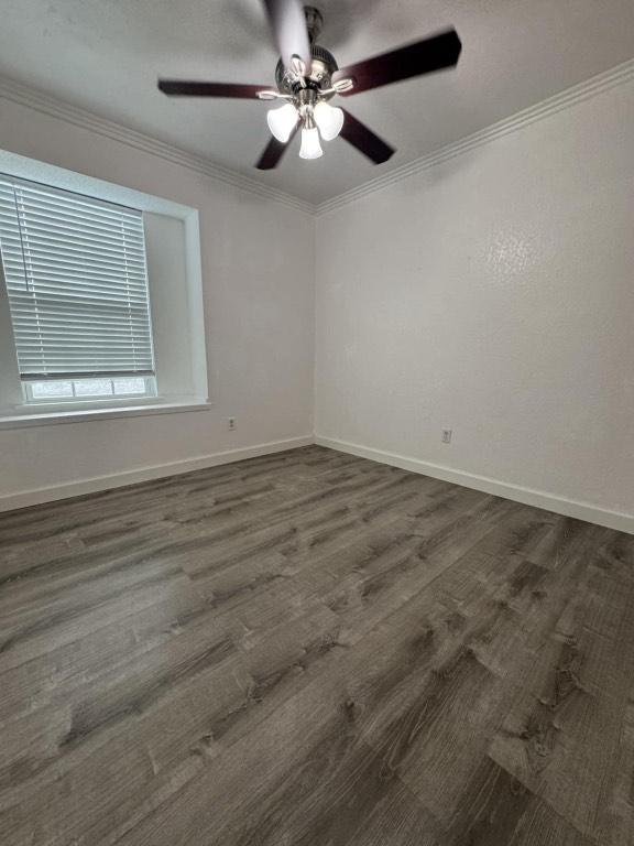 607 Garden Path Cv, Round Rock, TX 78664 - unfurnished room with a ceiling fan, crown molding, and dark wood-type flooring