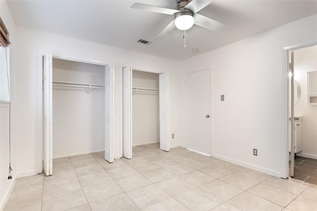 2122 Hancock Dr Unit 103, Austin, TX 78756 - unfurnished bedroom featuring multiple closets, light tile patterned floors, ceiling fan, and connected bathroom