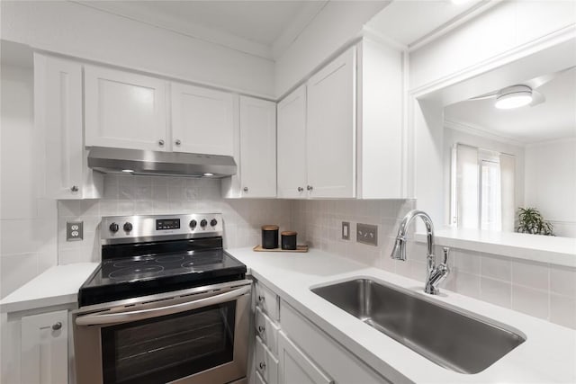 2122 Hancock Dr Unit 103, Austin, TX 78756 - kitchen featuring stainless steel range with electric cooktop, under cabinet range hood, crown molding, light countertops, and white cabinets