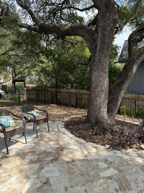 6203 Olympic Overlook Dr, Austin, TX 78746 - fenced backyard with a patio area