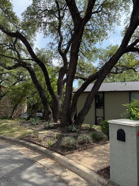 6203 Olympic Overlook Dr, Austin, TX 78746 - view of front of property with stucco siding and a shingled roof