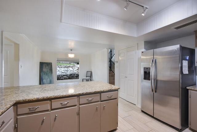 6203 Olympic Overlook Dr, Austin, TX 78746 - kitchen featuring stainless steel refrigerator with ice dispenser, track lighting, gray cabinetry, and light stone counters