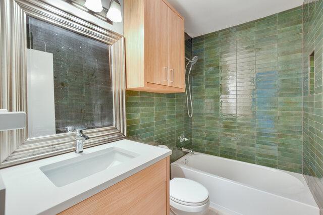 6203 Olympic Overlook Dr, Austin, TX 78746 - full bath featuring tile walls, vanity, and tub / shower combination