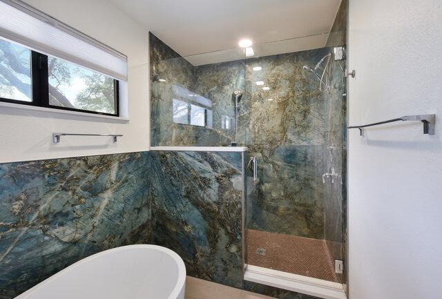6203 Olympic Overlook Dr, Austin, TX 78746 - bathroom with a marble finish shower and a soaking tub