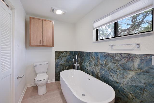 6203 Olympic Overlook Dr, Austin, TX 78746 - bathroom with a freestanding bath and plenty of natural light