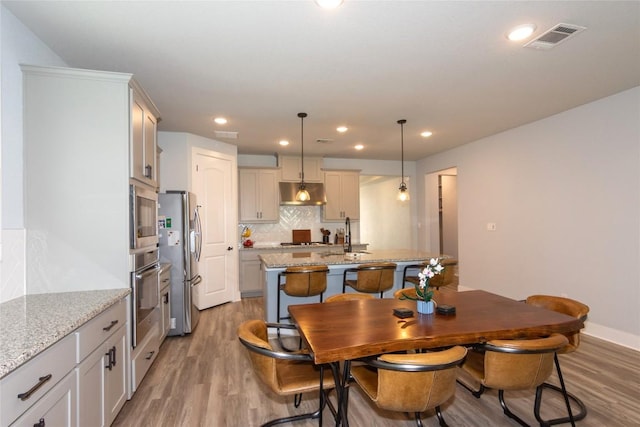 1328 Siena Sunset Rd, Leander, TX 78641 - dining room with light wood-style floors and recessed lighting